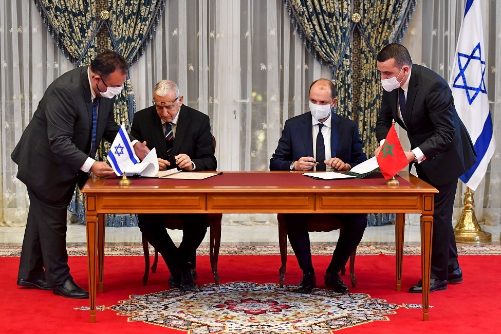TOPSHOT - Director General of Israel's Population and Immigration Agency Shlomo Mor-Yosef (L) and Minister Delegate to Morocco's Minister for Foreign Affairs Mohcine Jazouli sign an agreement at the Royal Palace in the Moroccan capital Rabat on December 22, 2020, on the first Israel-Morocco direct commercial flight, marking the latest US-brokered diplomatic normalisation deal between the Jewish state and an Arab country. (Photo by FADEL SENNA / AFP) (Photo by FADEL SENNA/AFP via Getty Images)